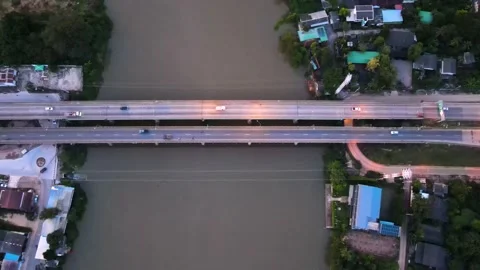 Drone view of the evening traffic over the bridge in a town in Thailand. Video stock 209236710