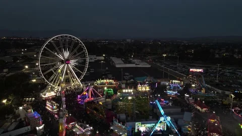 Drone view of fair at night with ferris wheel and rides 動画素材 162078104