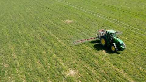 Drone view of a farm tractor spraying fields in Spain (3) Stock Footage 112242189
