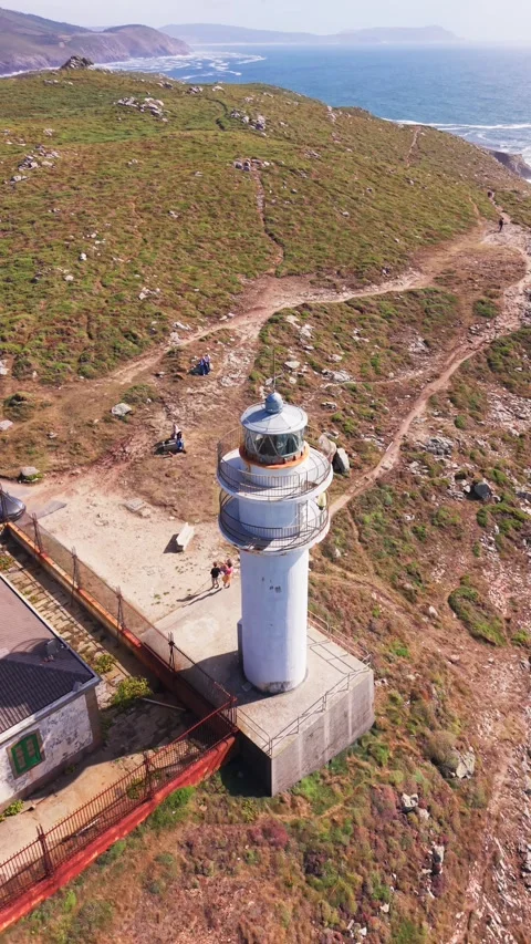 Drone view of Faro de Cabo Tourinan lighthouse above Atlantic cliffs in Galicia Stock Footage 345340938