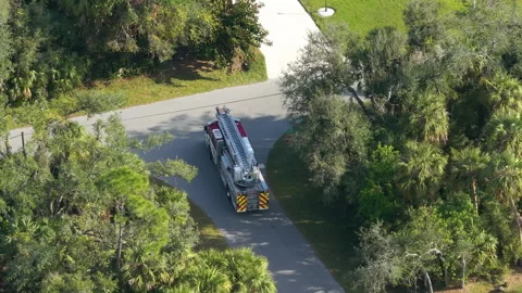 Drone view of fire truck responding to emergency on Florida roadway, showing Stock Footage 325404251