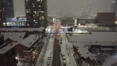 Drone View of Firetrucks Racing Through Snowy City Streets at Night – Urban Vidéo 311861385