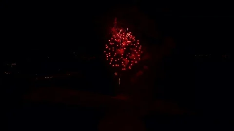 Drone view of the fireworks bursting over the ocean at night in Algarve Video stock 323874418