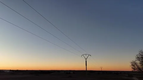Drone view in flight backwards of the detail of a power line and the sky at d Stock Footage 261383796
