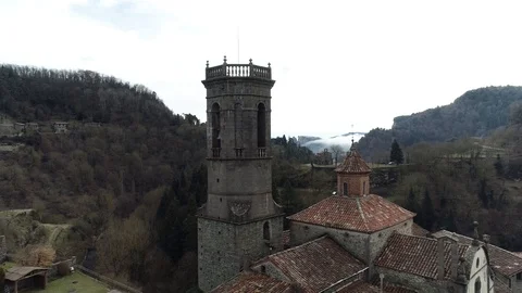 Drone view of flight between a bell tower and a church Stock Footage 102215402