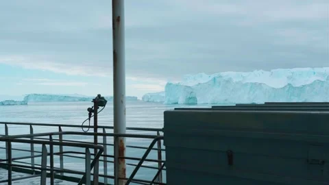 Drone view of floating melting icebergs and tour boat sailing in Arctic Stock Footage 324086994