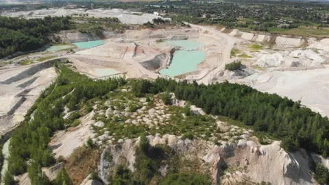 Drone view on a flooded kaolin quarry with turquoise water and white shore Stock Footage 138438134
