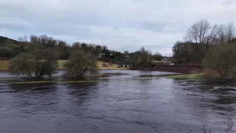 Drone View of Flooded River Near Rural Homes Under Overcast Sky Stock Footage 332504953