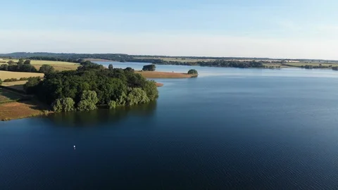 Drone View Flying Along Beautiful Wooded Reservoir Shore Stock Footage 113002774