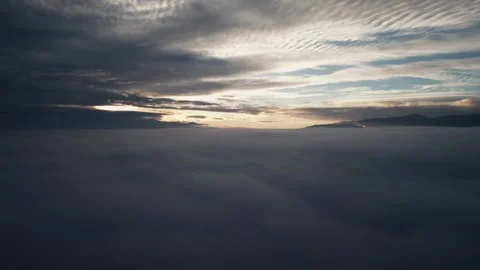 Drone view flying into dark clouds at sunrise Stock-Footage 323619292