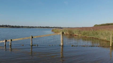 Drone View Flying Low Over Flat Lake Shore Rutland Water Reservoir 4K Cine D Stock Footage 113005780