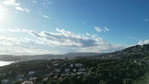 Drone view, flying over coastline with mountain and houses during sunset, 4K Stock Footage 274843677