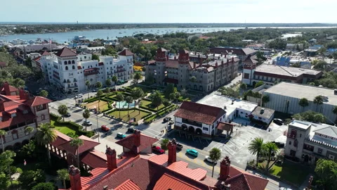 A drone view flying over Flagler College towards the Lightner Museum in St Stock Footage 327492326