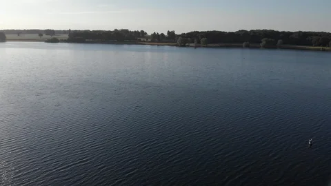 Drone View Flying Over Reservoir Rutland Water Normanton Church On Shore Aerial Stock Footage 112828242