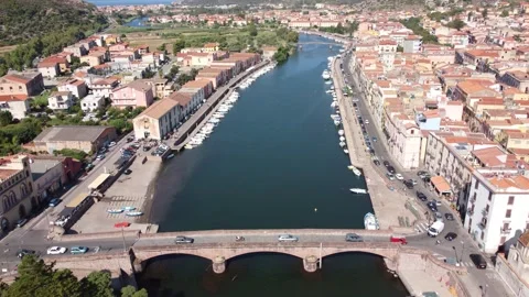 Drone view flying over the Temo river in Bosa moving from the Ponte Vecchio Stock Footage 252676674