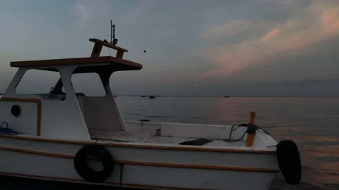 Drone view flying over the view from the fishing boat accompanied by seagulls at Stock Footage 230039686