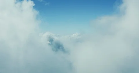 Drone view flying through a cloudscape under blue skies Stock Footage 118175045