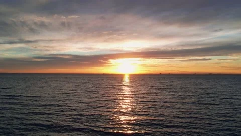 Drone view flying towards the sunset against the sea surface 動画素材 209131010