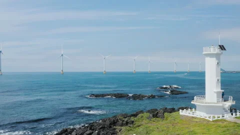 A drone view flying towards a wind turbine. Jeju Island. Jeju island. 스톡 동영상 136643869