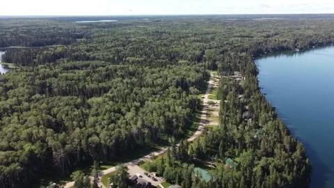 Drone view flyover of lake and forest in Manitoba in the summer Stock Footage 203231077