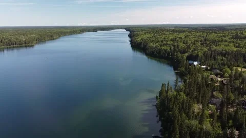 Drone view flyover of lake and forest in Manitoba in the summer Stock Footage 203231246