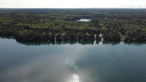 Drone view flyover of lake and forest in Manitoba in the summer Stock Footage 203232989