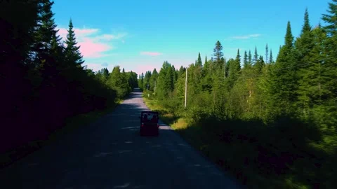 Drone view followed back by a side by side ride back HD Stock Footage 209400659