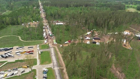 Drone view of a forest complex with parking areas, many buses, cars, roads Stock Footage 337245242