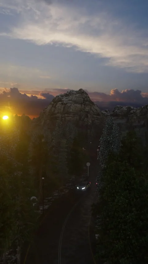 Drone view of forest road with car driving towards mountain at sunset, verti Stock Footage 340454877