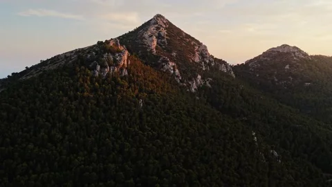 Drone view of forested mountain peak at sunrise in Spain Stock Footage 314605193