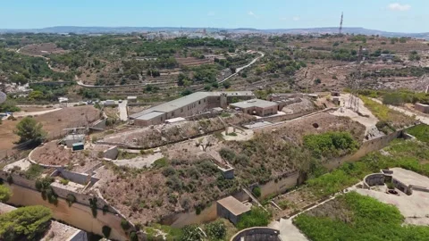 Drone view of Fort Madliena, Malta, with radar and coastal stone defenses Stock Footage 340111185