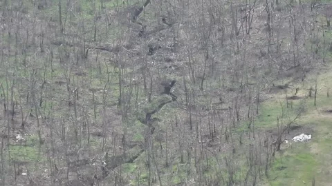 Drone View: FPV Kamikaze Strike on Hidden Dugout in Treeline Stockbeeldmateriaal 332355813