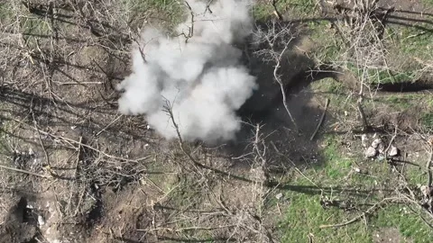 Drone View: FPV Strike on Concealed Trench Position in War Zone Stockbeeldmateriaal 332356157