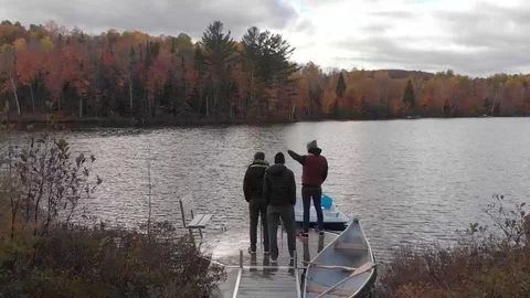 Drone view of friends looking a lake in Quebec during autumn season Stock Footage 104374541