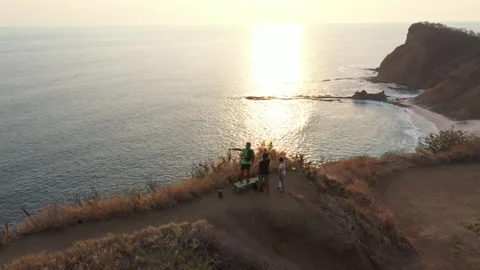 Drone view of Friends Watching Sunset from Ocean Cliff – Scenic Coastal View Stock Footage 313237938