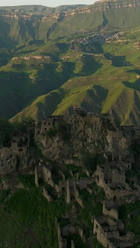 Drone view of Gamzutl ghost village ruins on mountain ridge in Dagestan at Stock Footage 346557546