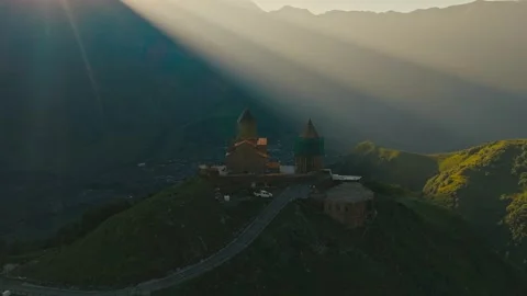 Drone View of Gergeti Trinity Church Kazbegi with Morning Light Rays over 库存影片 333110037