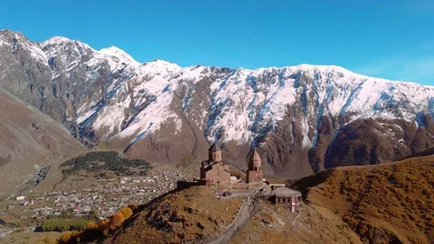 Drone view of Gergeti Trinity Tsminda Sameba Church in Mount Kazbegi Stock Footage 224920096