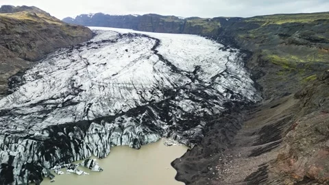 Drone view of glacier tongue between volcanic hills Iceland 4K Stock Footage 344250483