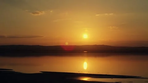Drone View Golden hues illuminating calm waters create a peaceful and conte.. Stock Footage 291994580
