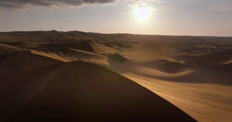 Drone View of Golden Sand Dunes at Sunset in Huacachina, Peru Stock Footage 344365530