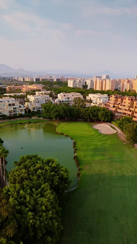 Drone view of golf course and urban skyline Stock Footage 311064404