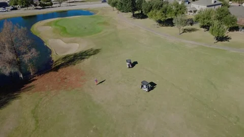 Drone View of Golfers in Golf Carts near a decorative Pond 03 Stock Footage 325808169
