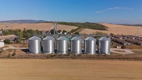 Drone view of grain silos and farm buildings in rural Pásztó, Hungary amid hills Stock Footage 345995433