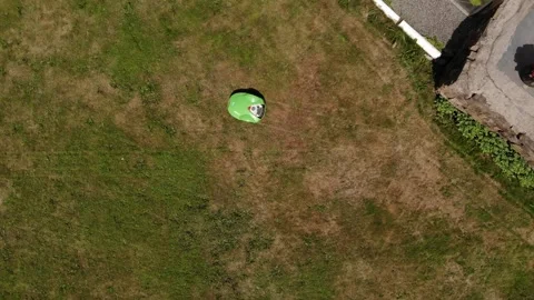 Drone view of a green autonomous lawnmower Stock Footage 334962279