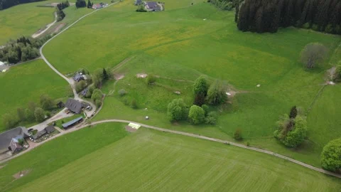 Drone view of green countryside fields and farms on a bright spring day Stock Footage 336626849