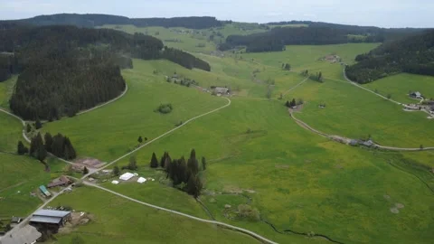 Drone view of green countryside fields and farms on a bright spring day Stock Footage 336626867