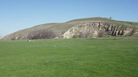 Drone View of Green Expanse with Rolling Hill Stock Footage 255982094