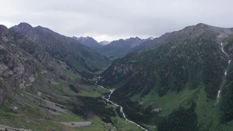 Drone view of a green gorge with high rocky cliffs Video stock 248120375