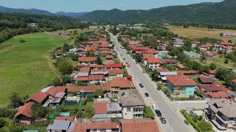 Drone view of green meadows beside a Bulgarian mountain village 库存影片 344626537